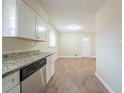 Kitchen with stainless steel dishwasher, granite countertops, and dark wood floor at 2104 Barbara Ln, Decatur, GA 30032