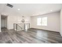 Spacious living room with hardwood floors and a modern light fixture at 1381 Flat Rock Rd, Stockbridge, GA 30281