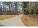 View of the home and front lawn with an extra long driveway at 270 Merrydale Dr, Fayetteville, GA 30215