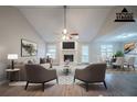 Bright and airy living room featuring vaulted ceilings, ceiling fan, fireplace, and neutral paint at 270 Merrydale Dr, Fayetteville, GA 30215