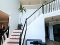 Open staircase with black spindles and geometric patterned risers at 13391 Henderson Dr, Hampton, GA 30228