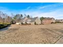 House with a large yard and neighborhood in background at 521 James Ridge Ln, Stockbridge, GA 30281