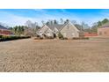 Brick house with a grassy yard and neighborhood view at 521 James Ridge Ln, Stockbridge, GA 30281