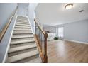 Inviting entryway featuring wood floors, staircase with wood and iron, and freshly painted walls at 296 Cedar Bay Cir, Dallas, GA 30157