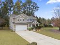 A delightful view of a two-story home with a well-maintained lawn and long driveway at 296 Cedar Bay Cir, Dallas, GA 30157