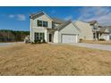 Charming two-story home with a two-car garage and manicured lawn in a suburban setting at 7889 Winkman Dr, Fairburn, GA 30213