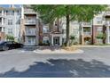 Welcoming condo building entrance with well-maintained landscaping at 1965 Nocturne Dr # 1205A, Alpharetta, GA 30009