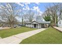 Well-kept front lawn, long driveway, and attached carport at 327 Thornton Sw St, Atlanta, GA 30315