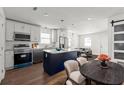 Eat-in kitchen featuring white cabinets, stainless steel appliances, and a granite island at 327 Thornton Sw St, Atlanta, GA 30315