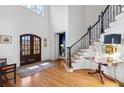 Inviting foyer with hardwood floors, a grand staircase, and plenty of natural light from the front door at 110 Mattison Cv, Atlanta, GA 30319