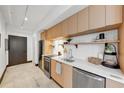 Modern kitchen with stainless steel appliances, light wood cabinetry, and bright white countertops at 1805 Harvard Ave # 306, College Park, GA 30337