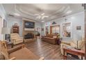 Cozy living room featuring a stone fireplace, hardwood floors, and a comfortable seating arrangement at 217 Chad Ln, Loganville, GA 30052