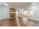 Bright living room with hardwood floors, stone fireplace, and abundant natural light at 217 Chad Ln, Loganville, GA 30052