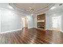 Spacious living room features hardwood floors, a stone fireplace, and recessed lighting at 217 Chad Ln, Loganville, GA 30052