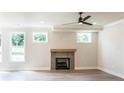 Cozy living room features hardwood floors, a tiled fireplace, recessed lights, and natural light at 2475 Adair Ridge Ct, Decatur, GA 30034