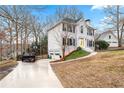 Beautiful two-story home featuring a two-car garage, white brick and a yellow door at 3524 Pine Grove Drive, Douglasville, GA 30135