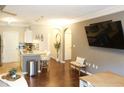 Cozy living room with hardwood floors, a kitchen view, and neutral wall colors at 4333 Dunwoody Park # 2104, Dunwoody, GA 30338