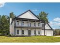 Beautiful two-story home with a double porch, offering curb appeal with manicured lawn and classic design at 4566 Town Manor Dr, Douglasville, GA 30135