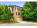 Charming brick home with a two-car garage, beautiful landscaping, and inviting front entrance at 938 Canterbury Ln, Atlanta, GA 30324