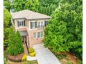 Aerial view of charming brick home with a two-car garage and a beautifully landscaped front yard at 938 Canterbury Ln, Atlanta, GA 30324