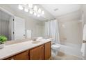 Bathroom features a large vanity, and a tub with shower at 1219 Waterville Ct, Alpharetta, GA 30022