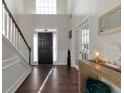 Elegant foyer with hardwood floors, a staircase, and a view of the front door and a side door at 1348 Rolling Stream Way, Lawrenceville, GA 30043