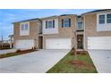 Beautiful townhome with brick facade, a white garage door, and well-manicured lawn at 305 Heavenly Hollow Pl, Mcdonough, GA 30253