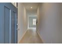 Modern hallway with light wood floors, white walls, and a clear view into the open-concept living space at 305 Heavenly Hollow Pl, Mcdonough, GA 30253