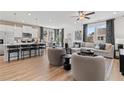 Inviting living room showcasing an open layout with a ceiling fan, modern furniture, and abundant natural light at 305 Heavenly Hollow Pl, Mcdonough, GA 30253