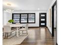 Elegant dining room featuring modern lighting, a dining table with seating, and dark hardwood floors at 3661 W Potomac Dr, East Point, GA 30344