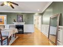 Spacious dining room with hardwood floors, fireplace, detailed trim, and a view into other rooms at 946 Highland Ne Vw, Atlanta, GA 30306