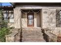 Close up view of a front entrance featuring brick columns, stone steps, and decorative lighting at 946 Highland Ne Vw, Atlanta, GA 30306