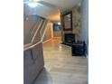 Inviting living room featuring hardwood floors, a stone fireplace, and staircase at 497 Prince Of Wales, Stone Mountain, GA 30083