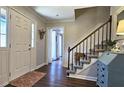 Inviting foyer with hardwood floors, staircase, and views to other rooms through doorway at 744 Dean Way, Lawrenceville, GA 30044