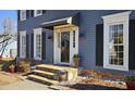 Close up of the home's front door, black awning, and stone steps leading to the entryway at 744 Dean Way, Lawrenceville, GA 30044