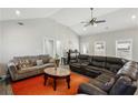 Comfortable living room featuring cozy sofas, ceiling fan, an orange rug and a bar at 992 Yemassee Trl, Stone Mountain, GA 30083