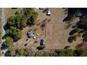 Overhead shot of a countryside home with expansive land, trees, and outbuildings at 5570 Bold Springs Rd, Dacula, GA 30019