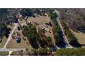 Picturesque aerial view of a country estate with lush greenery and a winding road at 5570 Bold Springs Rd, Dacula, GA 30019