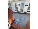 Inviting entrance with a painted wood porch, a storm door, and a brick railing at 509 Arnold Rd, Lawrenceville, GA 30044