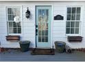 Charming front entrance with a glass paneled door, sidelight windows, and potted plants at 509 Arnold Road, Lawrenceville, GA 30044