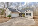 Ranch-style home featuring a two-car garage and concrete driveway at 5833 Westerling Pl, Powder Springs, GA 30127