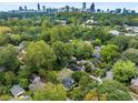 Scenic aerial view of a home nestled amongst lush greenery with the Atlanta skyline in the background at 645 Cumberland Rd, Atlanta, GA 30306