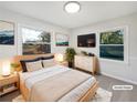 Cozy main bedroom with large windows and neutral decor, virtually staged at 773 Cone Rd, Forest Park, GA 30297