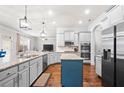 Bright kitchen featuring stainless appliances, granite counters, and blue kitchen island at 2268 Austin Common Way, Dacula, GA 30019