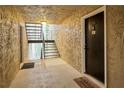 Hallway features stairs, textured walls, and a black door with unit number at 3140 Seven Pines Ct # 202, Atlanta, GA 30339