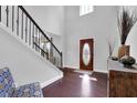 Bright foyer with hardwood floors, staircase, and natural light from a window above the front door at 48 Scenic Ovlk, Acworth, GA 30101