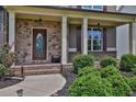 Inviting front porch with stone accents and lush landscaping enhances the home's curb appeal at 48 Scenic Ovlk, Acworth, GA 30101