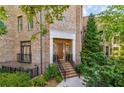 Brick townhome featuring a stone front porch and well-manicured landscaping at 3631 Habersham Nw Rd, Atlanta, GA 30305