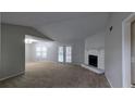 Spacious living room with high ceilings, a cozy stone fireplace, and sliding glass doors to the outside at 3515 Weathered Wood Dr, Ellenwood, GA 30294