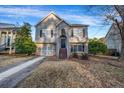 Traditional two-story home featuring stone accents, a manicured lawn, and inviting curb appeal at 5806 Highgrove Dr, Atlanta, GA 30349